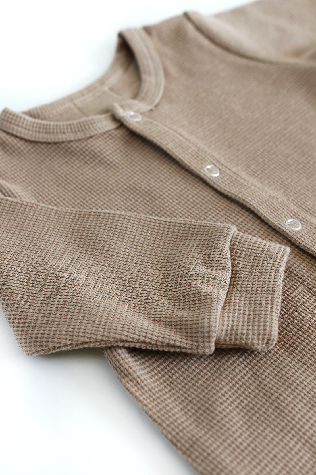 Gift shopping for infant essentials or creating a baby registry, you have found the best neutral tone unisex 100% cotton waffle sleepsuit onesie.