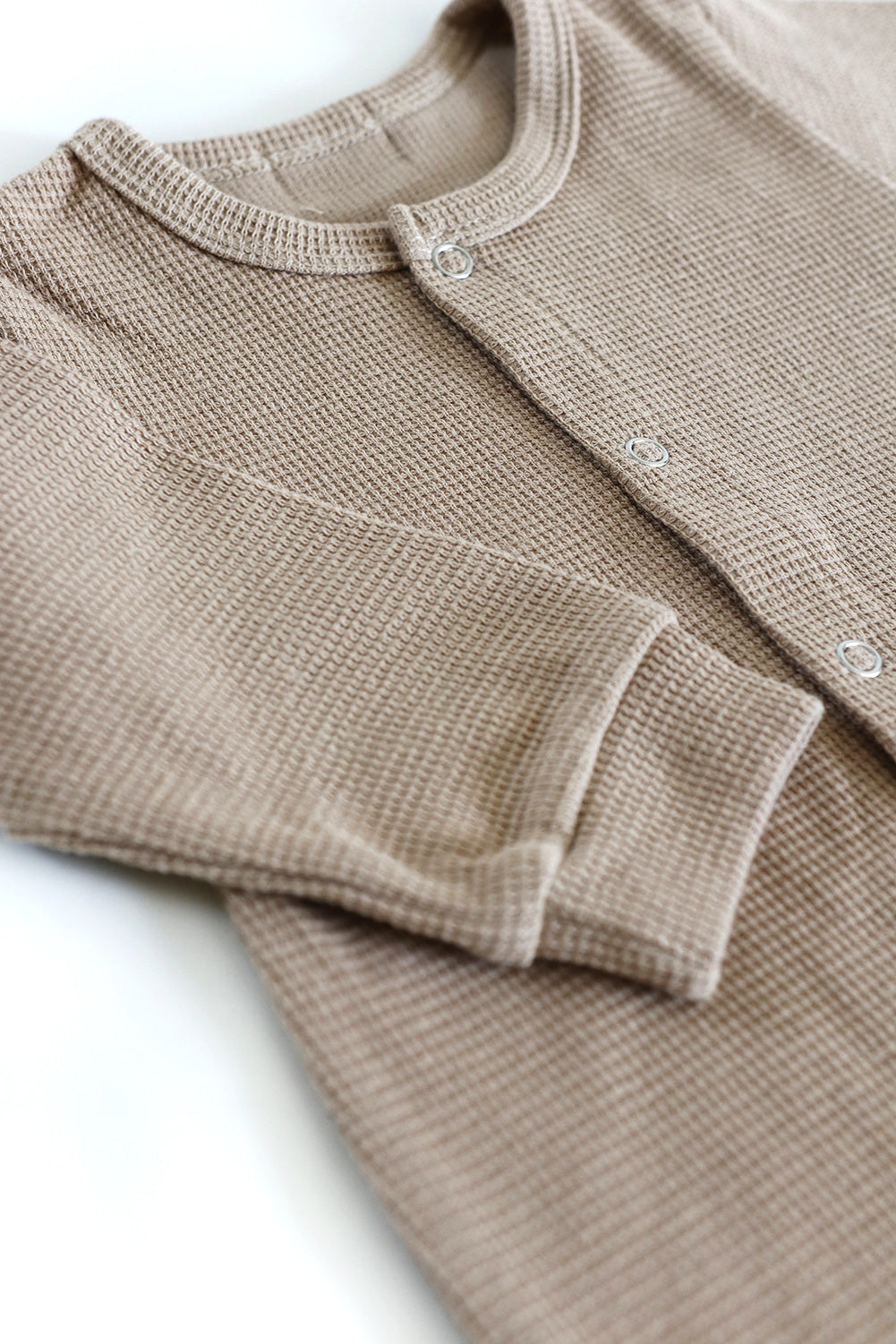 Gift shopping for infant essentials or creating a baby registry, you have found the best neutral tone unisex 100% cotton waffle sleepsuit onesie.
